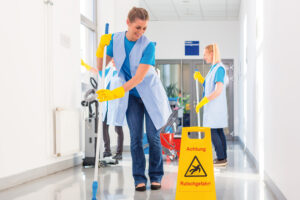 Commercial cleaning brigade working mopping the floor